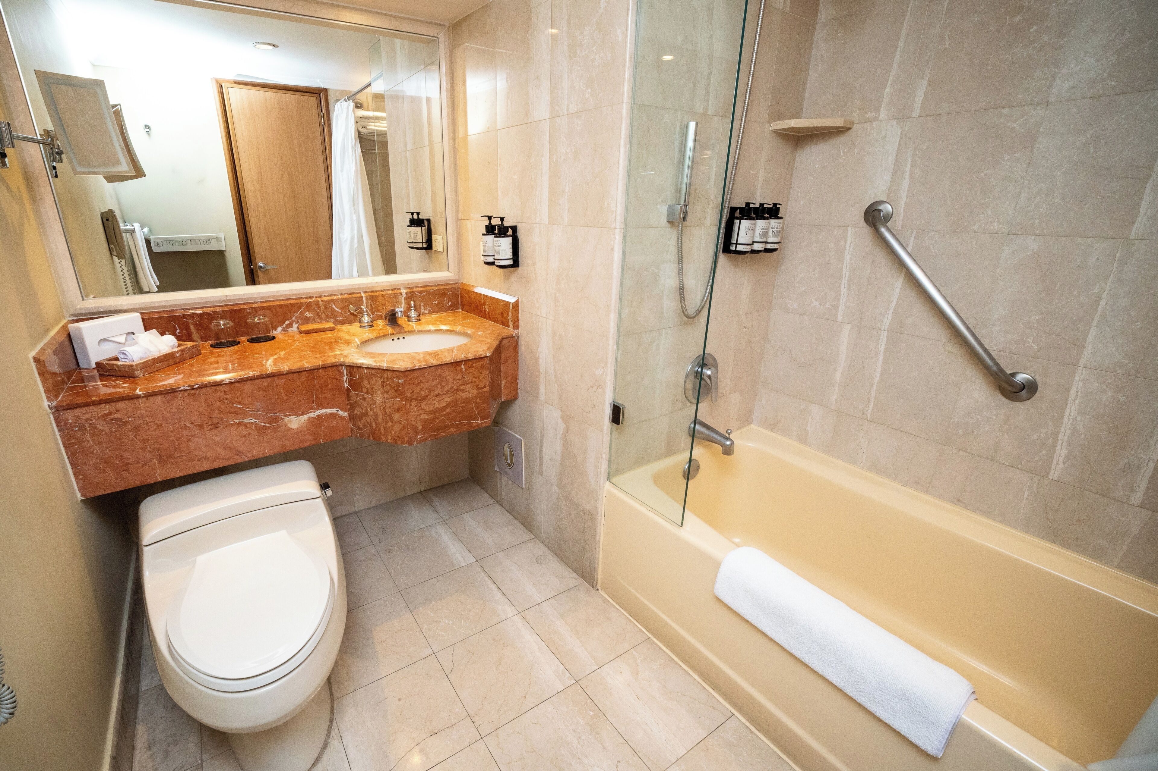 A bathroom with a toilet, sink, and bathtub.