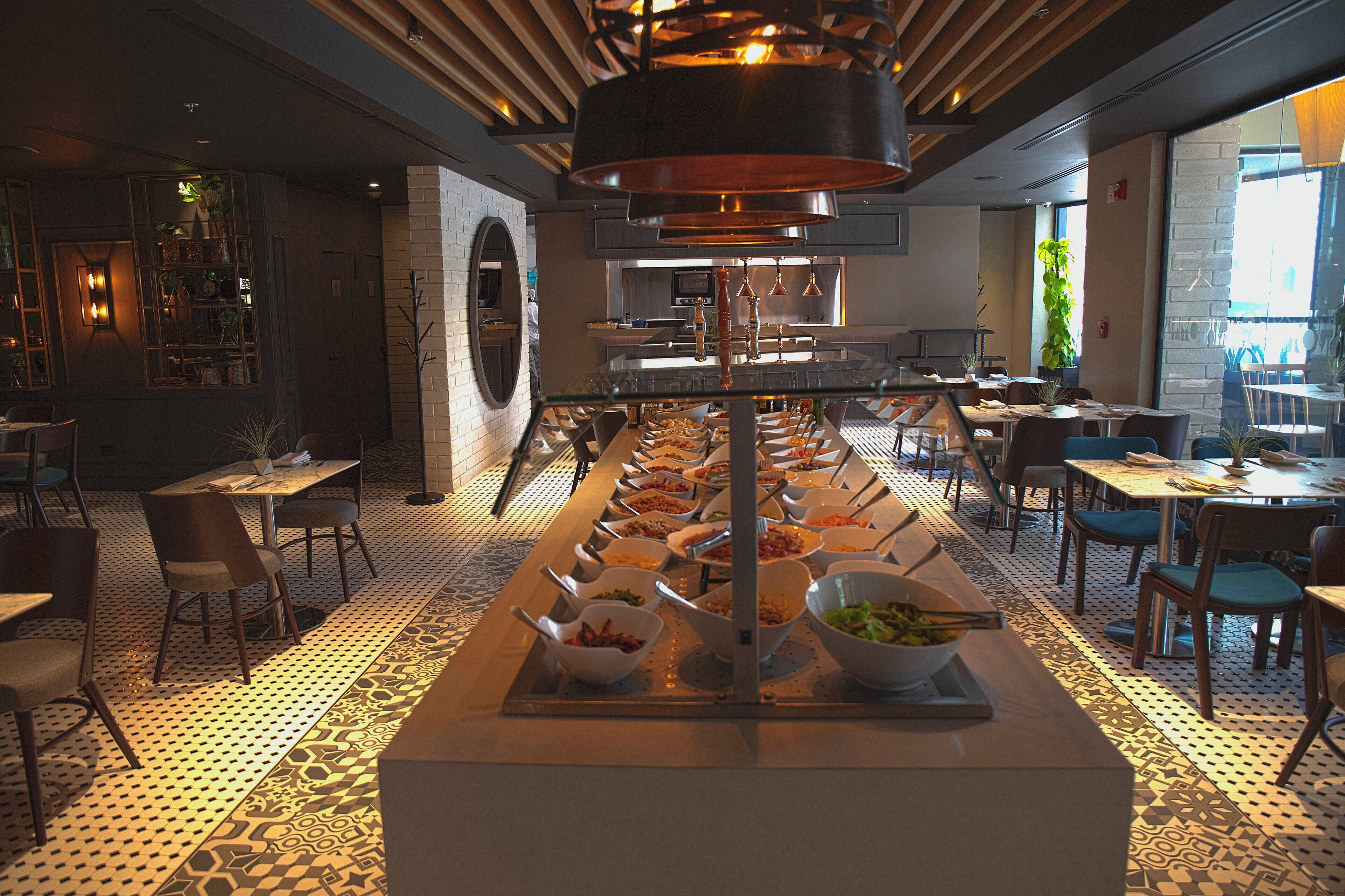 A buffet setup with multiple serving stations and a variety of dishes.