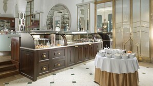A buffet area with a variety of food options, a coffee station, and a dessert display. - Hotel Paris Prague (Prague)