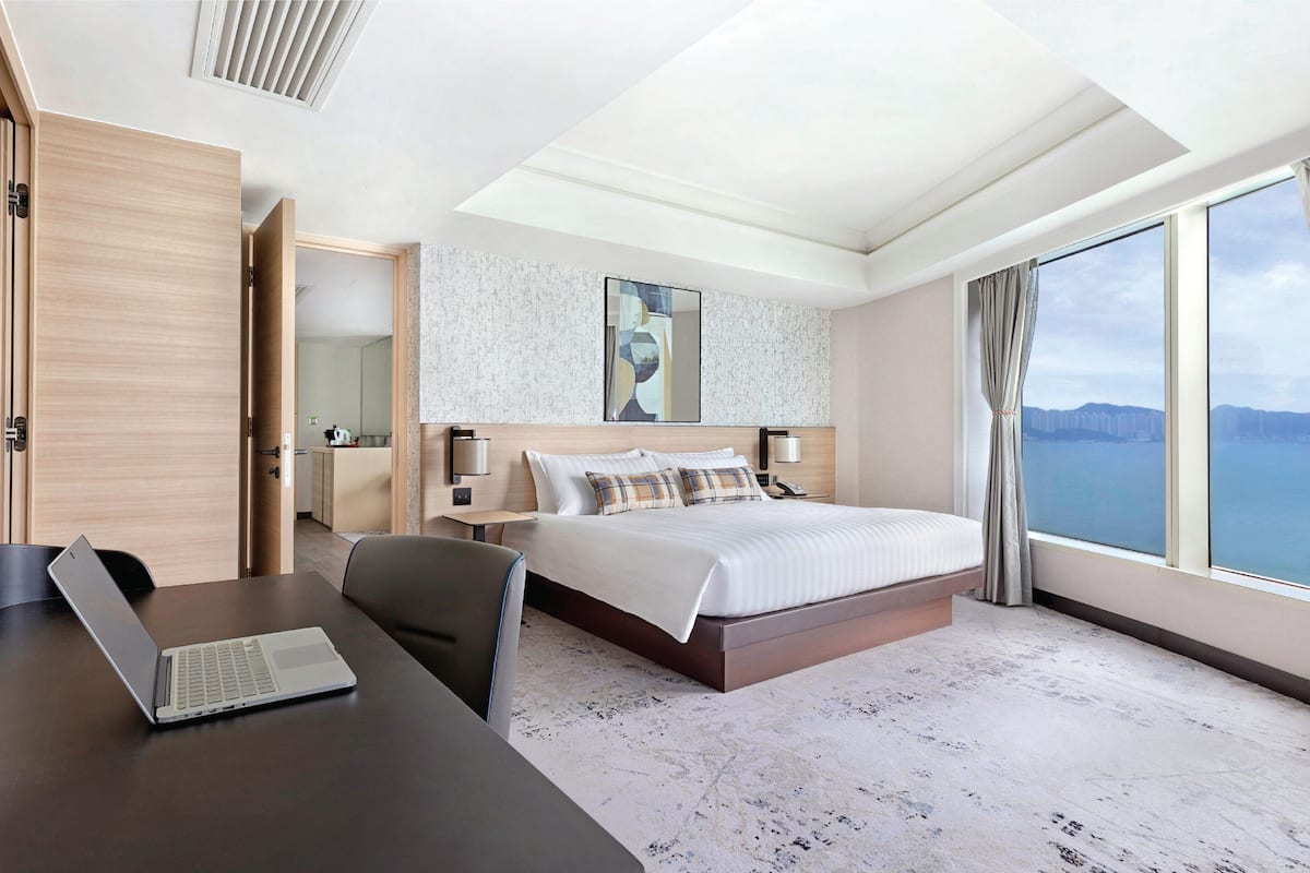 deluxe harbourview suite | in-room safe, desk, blackout curtains, iron/ironing board