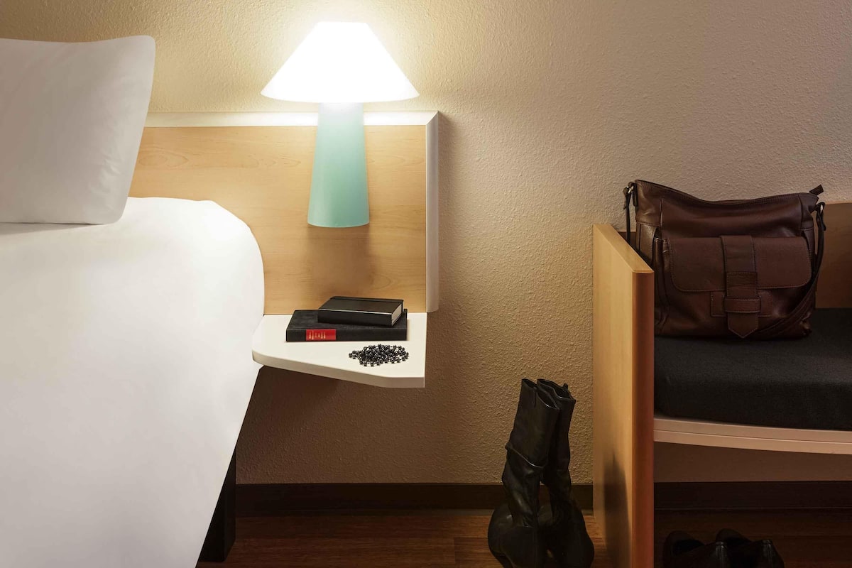 Hypo-allergenic bedding, desk, laptop workspace, blackout drapes