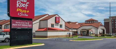 A Red Roof Plus Suites hotel with a clear sky.