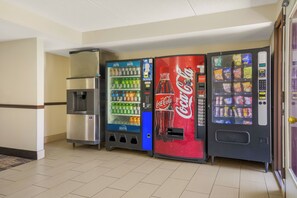 Una hilera de máquinas expendedoras con diversas bebidas y aperitivos.