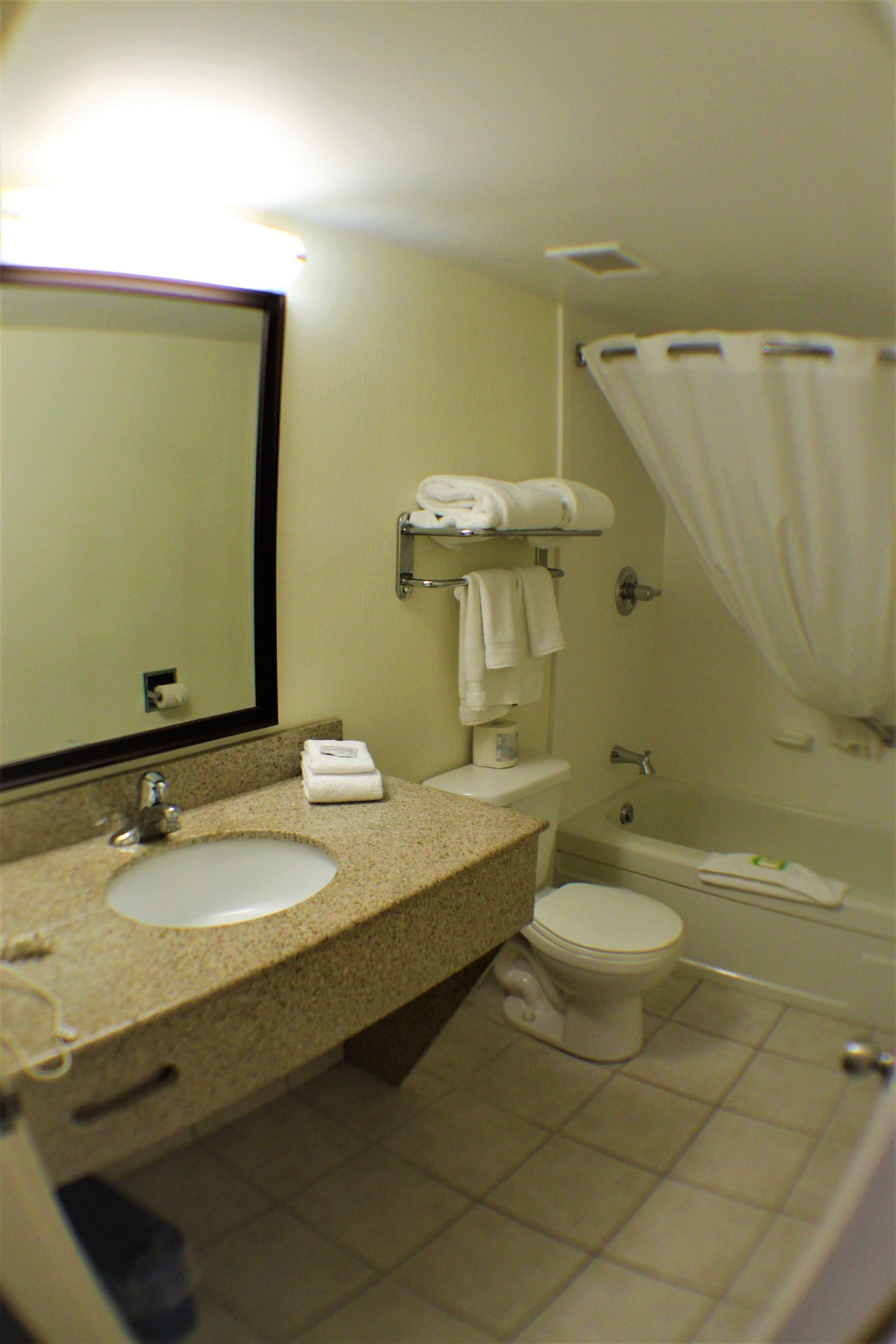 A bathroom with a sink, toilet, and bathtub.