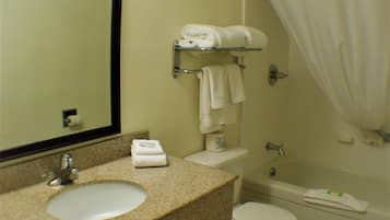 A bathroom with a sink, toilet, and bathtub.