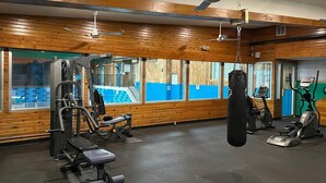 A gym with wooden walls, a punching bag, and various exercise equipment. - Charlottetown Inn & Conference Centre (Charlottetown)