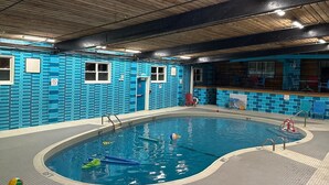 An indoor swimming pool with blue tiled walls and a wooden ceiling. - Charlottetown Inn & Conference Centre (Charlottetown)