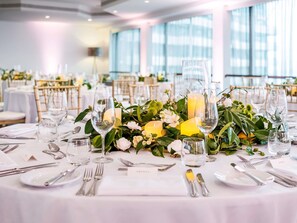 A well-set dining table with candles, glassware, and a name card. - Pullman Auckland Hotel & Apartments (Auckland)