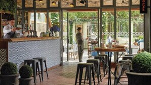 Ein Restaurant mit Terrasse, Barbereich und Außenbestuhlung.