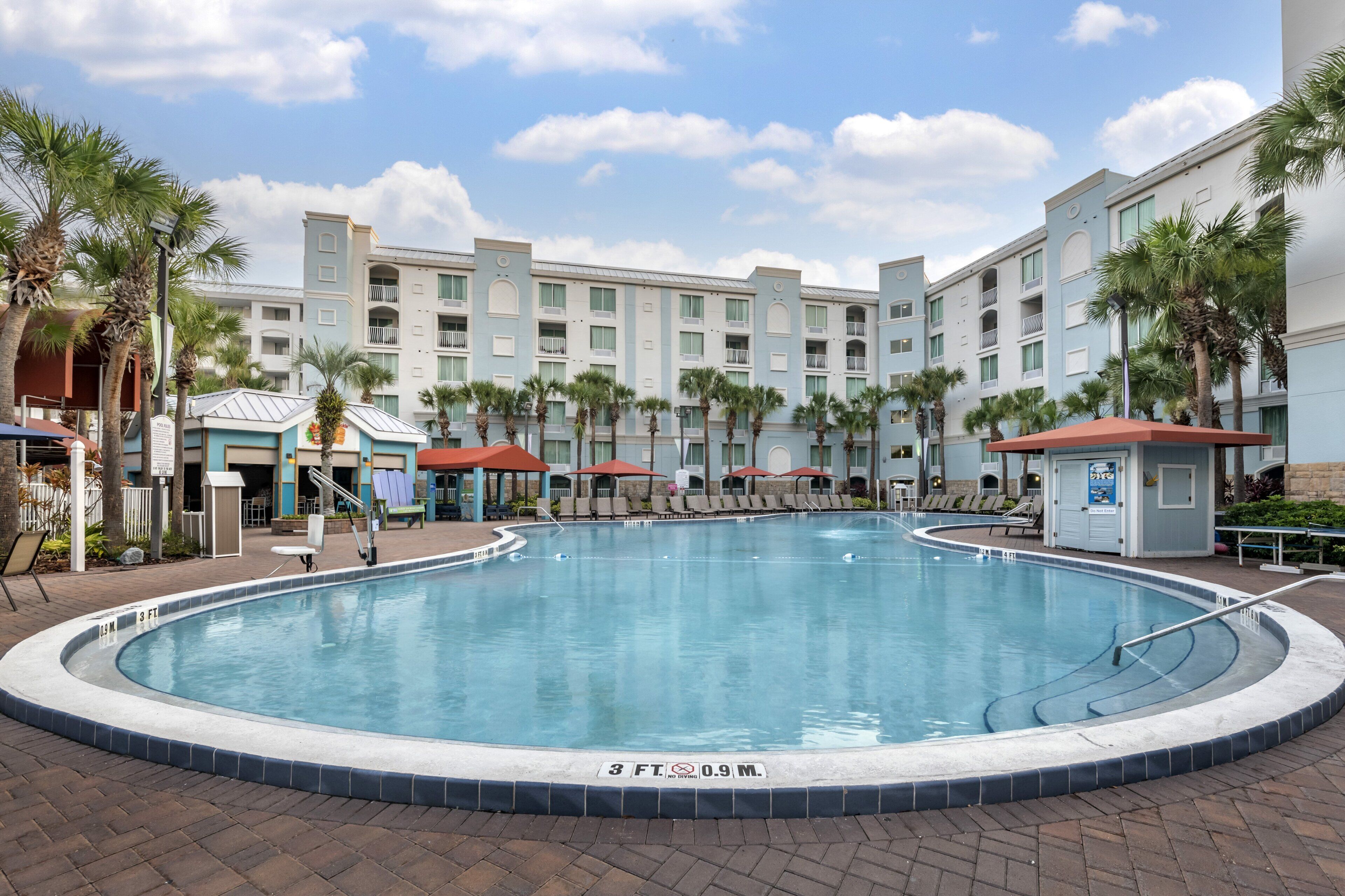 Outdoor pool, a heated pool, pool umbrellas, pool loungers