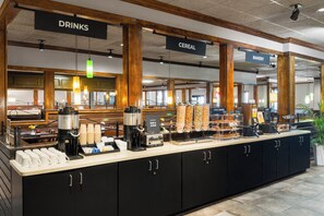 A breakfast bar with coffee machines, cereal, and bakery items. - Holiday Inn Resort Orlando - Lake Buena Vista by IHG (Orlando)