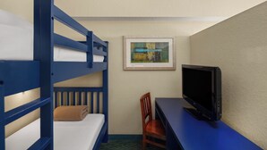 A hotel room with bunk beds, a desk, a chair, a television, and a framed picture on the wall. - Holiday Inn Resort Orlando - Lake Buena Vista by IHG (Orlando)