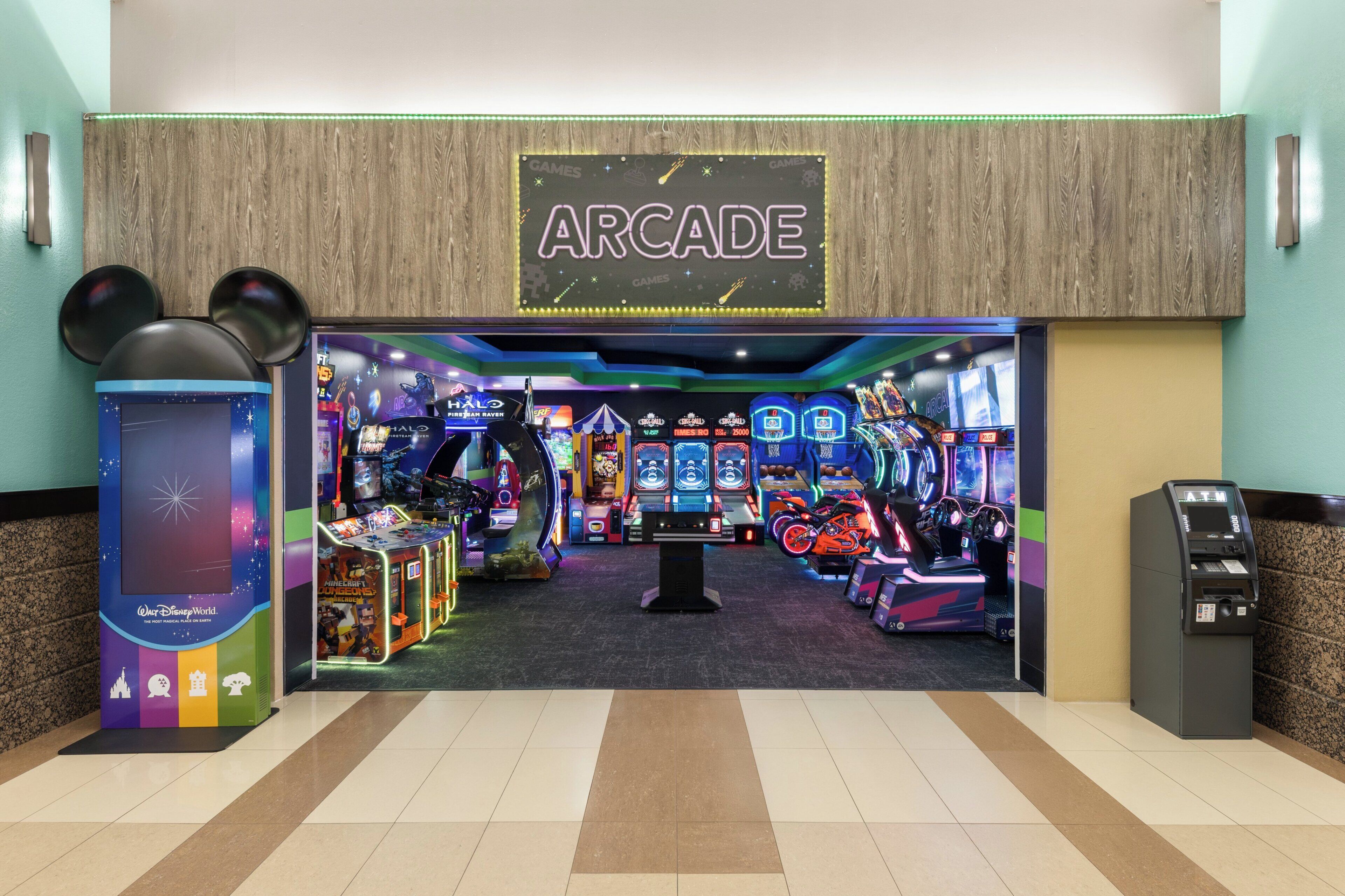 An arcade with various gaming machines and a sign that reads 'ARCADE'.