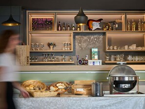 A bar area with shelves of bottles, glasses, and a chalkboard menu. - ibis Chur (Chur)