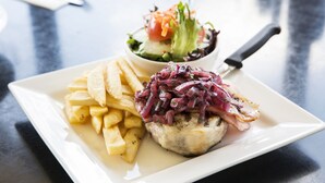A plate of food with a salad and fries.