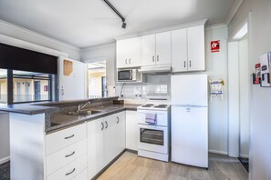 Three Bedroom Apartment | Private kitchen | Microwave, coffee/tea maker, electric kettle