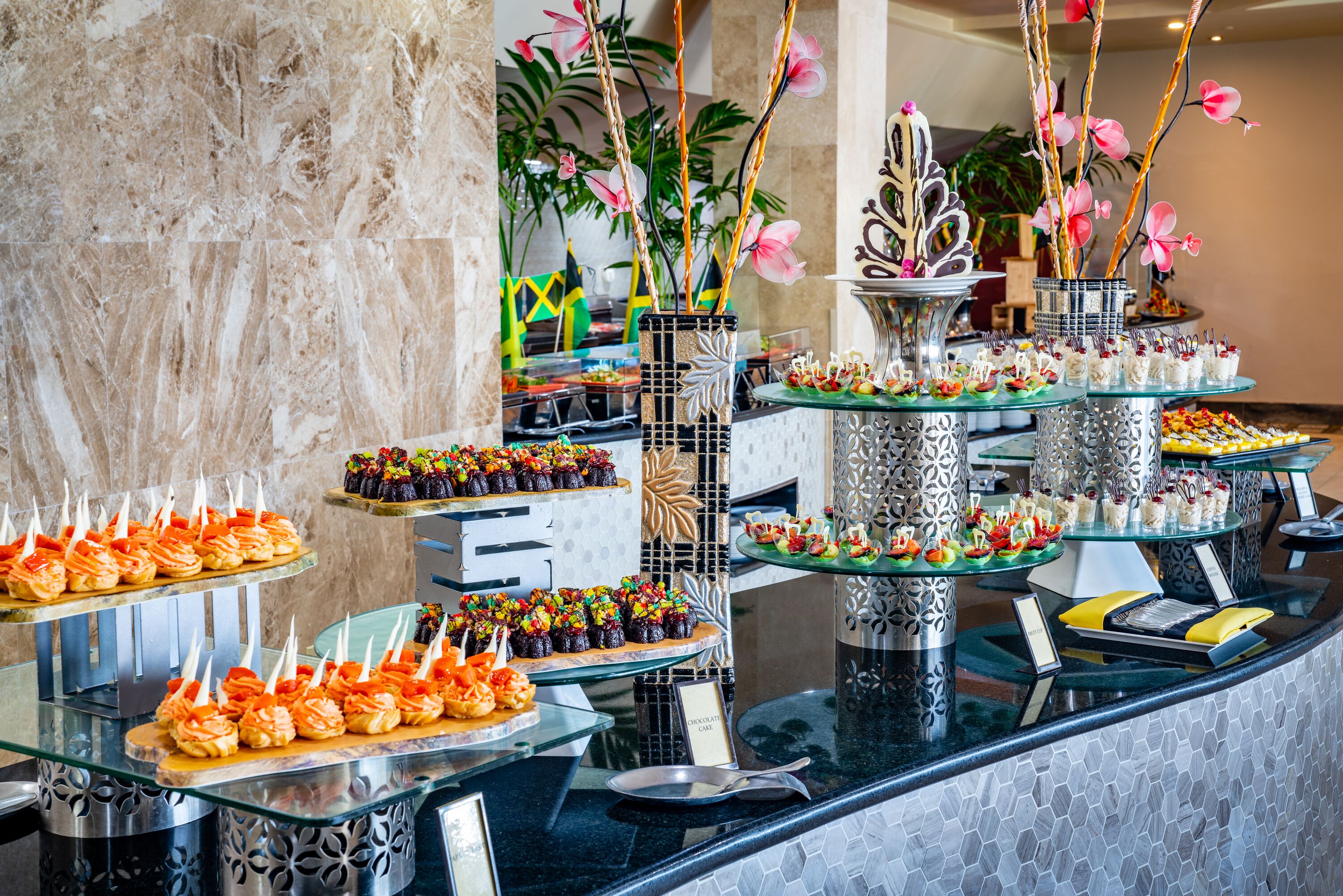 A buffet with various food items and decorative elements.