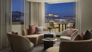 A modern living room with a view of a cityscape and a historic building.