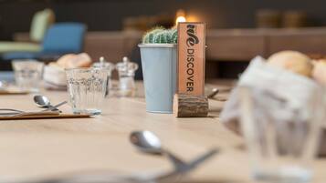 A table set with glasses, cutlery, a cactus, and a sign reading 'WE DISCOVER ESPACES'.