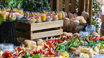 A buffet with various food items and drinks.