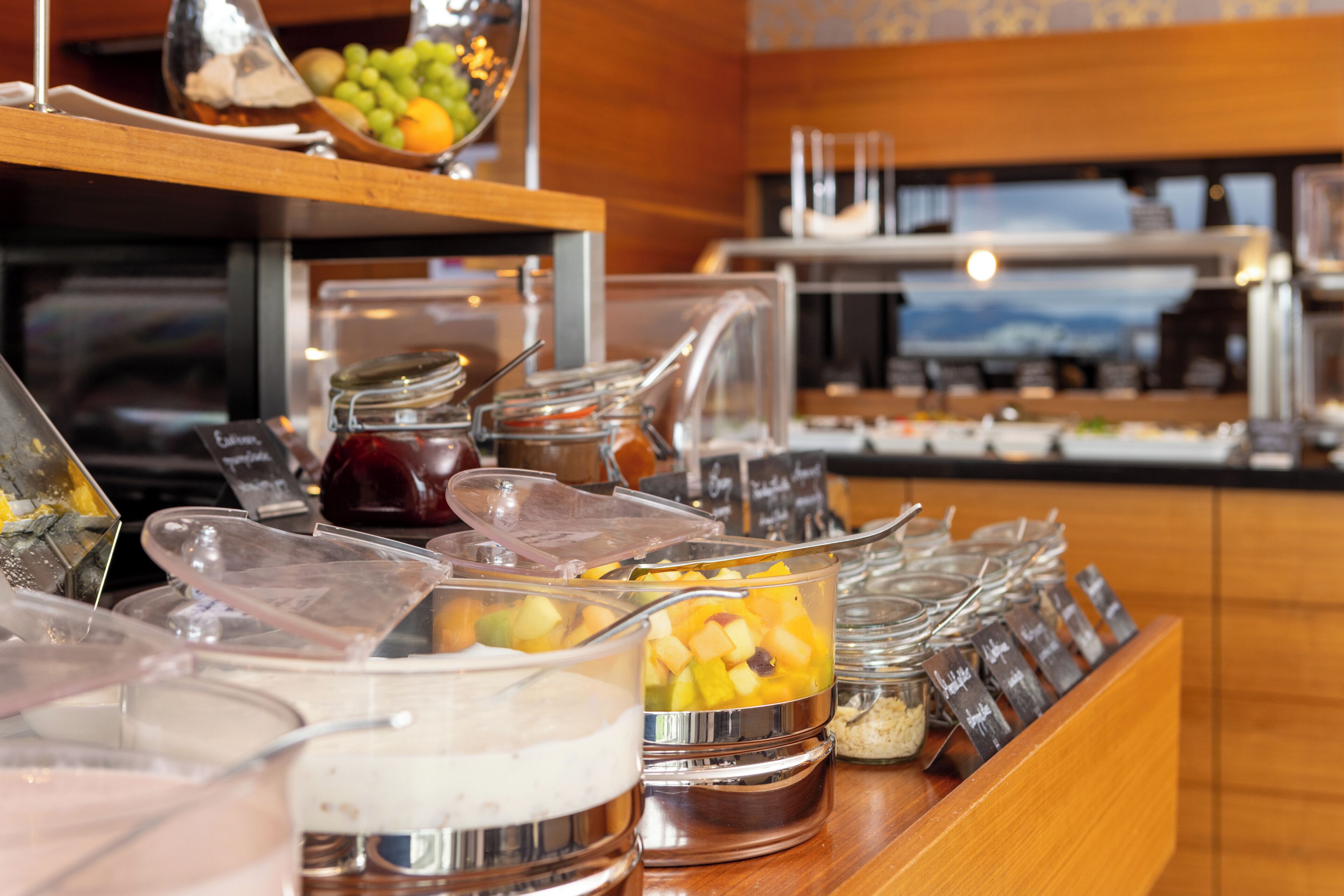 A buffet with various food items and condiments.