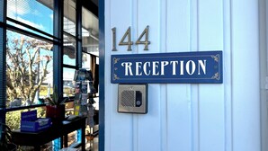 A reception sign with the number 144 and the word 'RECEPTION' on a white wall.