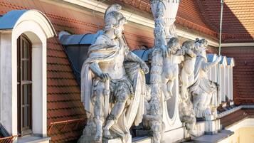 Eine Reihe klassischer Statuen an einer Gebäudefassade.