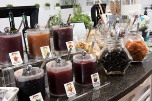 Enjoy a variety of drinks and snacks at our buffet, featuring Därbö beverages and a selection of nuts and dried fruits.