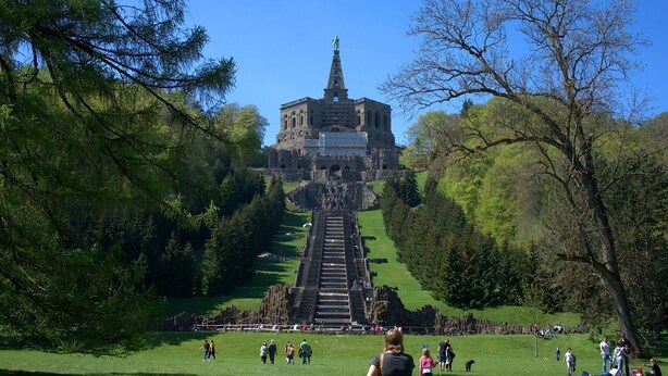 A large, historic building with a central staircase leading to a statue. - Wyndham Garden Kassel (Kassel)
