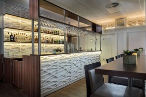 Enjoy a drink at the bar, where a unique geometric pattern and comfortable seating await.