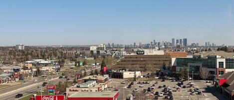 A parking lot with several cars, a Tim Hortons, and a Coca-Cola sign.
