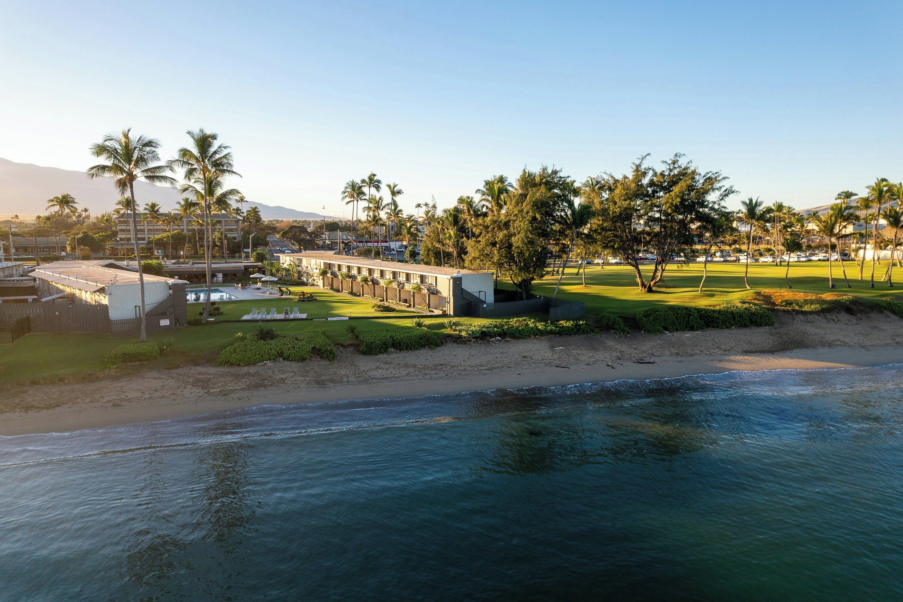 A coastal hotel with a pool, a golf course, and a beach.