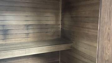 A corner of a room with wooden paneling and a tiled floor.