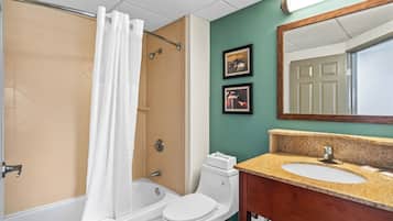 Un baño con bañera, inodoro y lavamanos.