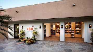 A building with a sign reading 'nui' and a storefront with various products.