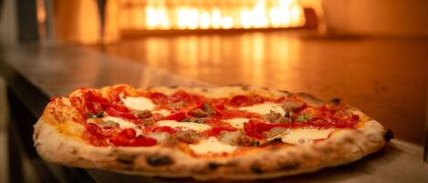 A pizza in a brick oven.