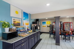 A kitchen area with a microwave, coffee maker, and a buffet setup. - Days Inn by Wyndham Greeneville (Greeneville)