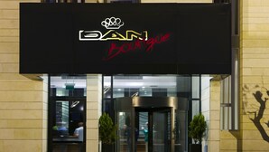 A boutique hotel entrance with a revolving door and a sign above that reads "BAN Boutique". - Dan Boutique Jerusalem (Jerusalem)