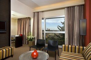 Deluxe Room, City View | Living area | 26-inch LCD TV with digital channels, TV