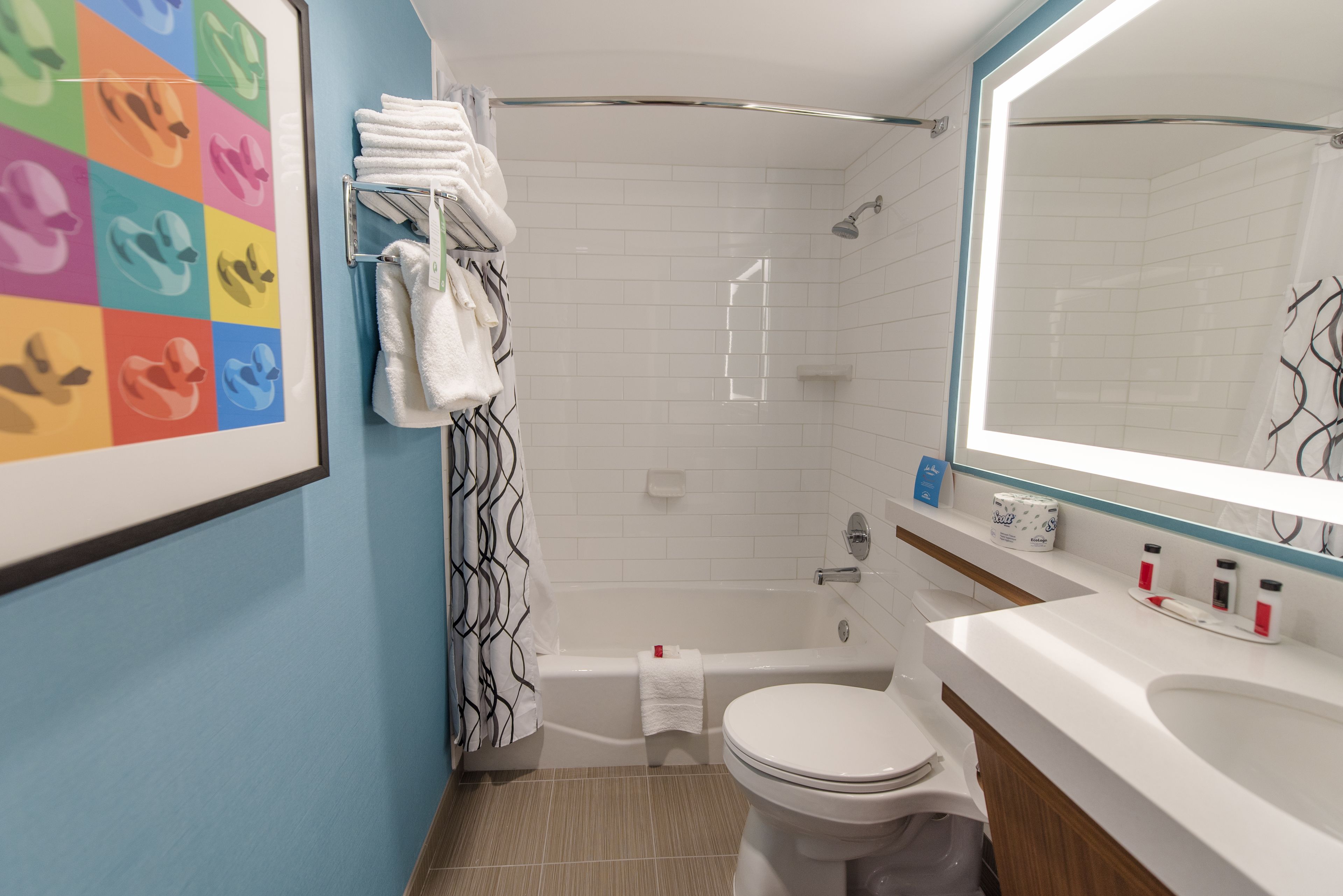 A bathroom with a shower, toilet, and sink.