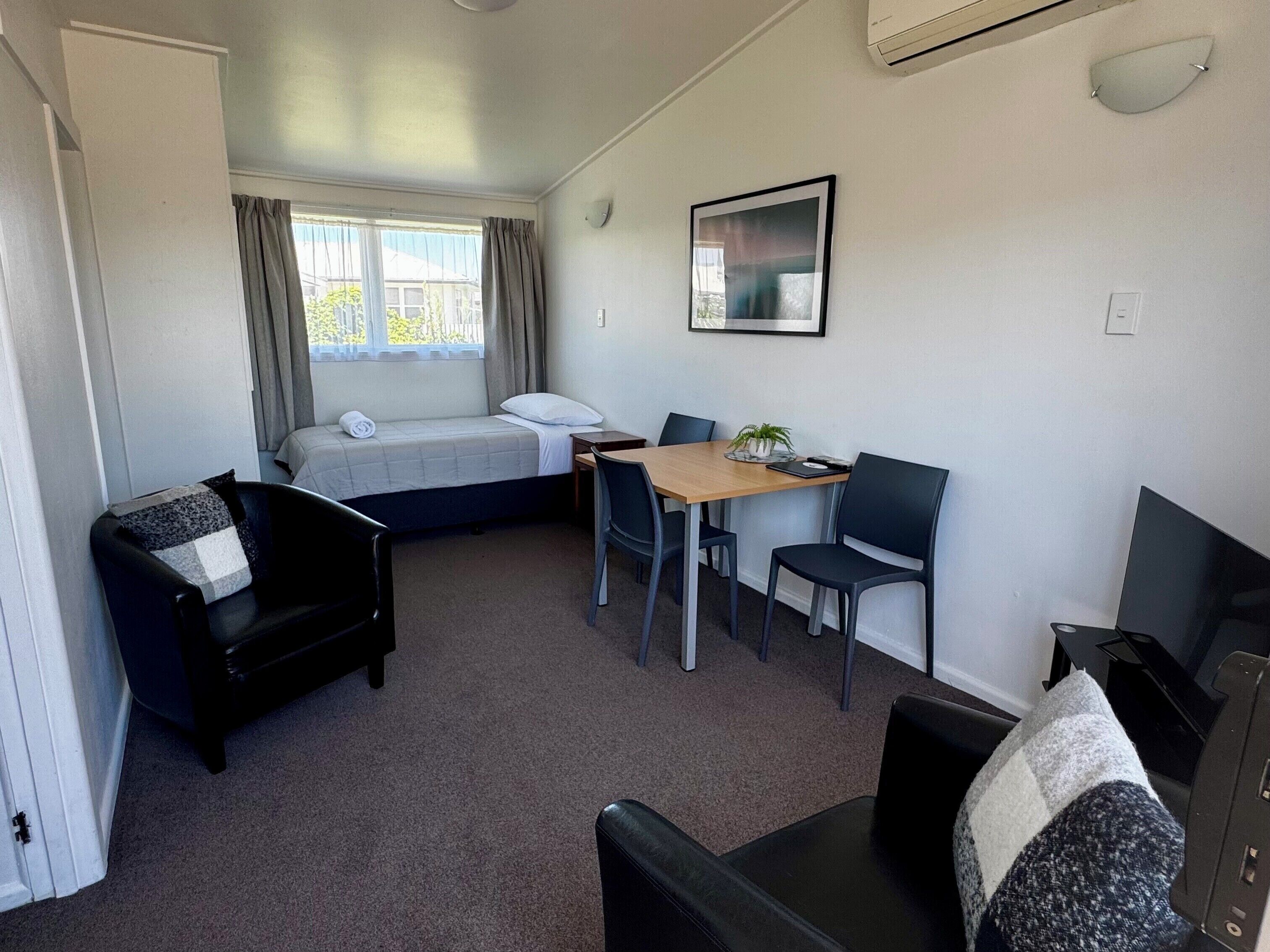 Executive Studio | Living area | 30-inch LCD TV with cable channels, TV, streaming services