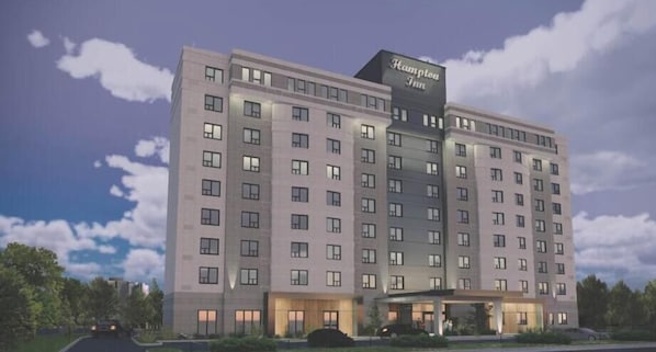 A multi-story hotel with a prominent sign reading 'Hampton Inn.' - Hampton Inn by Hilton Montreal East Anjou (Montreal)