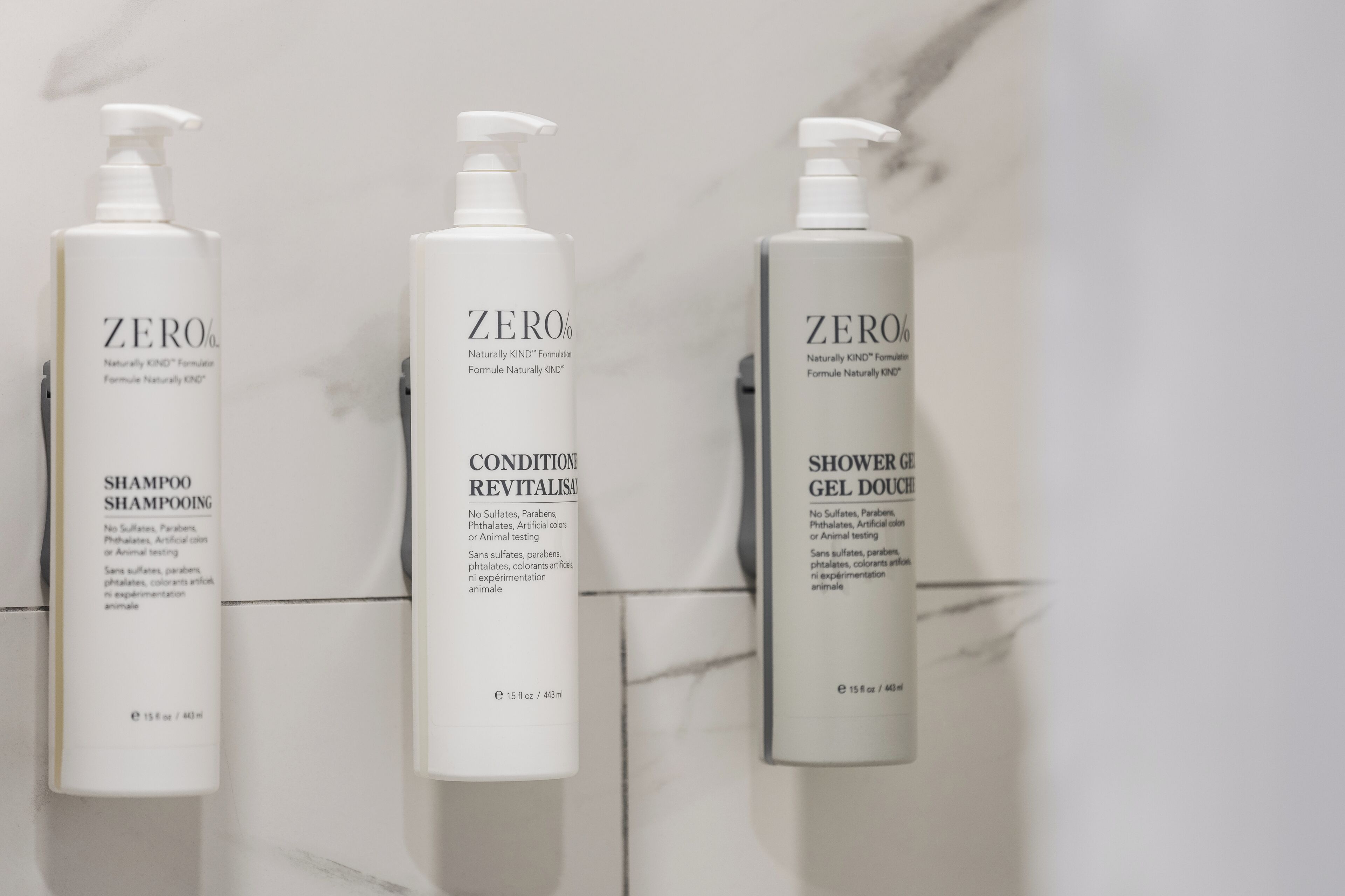 Three bottles of Zero% shampoo, conditioner, and shower gel.