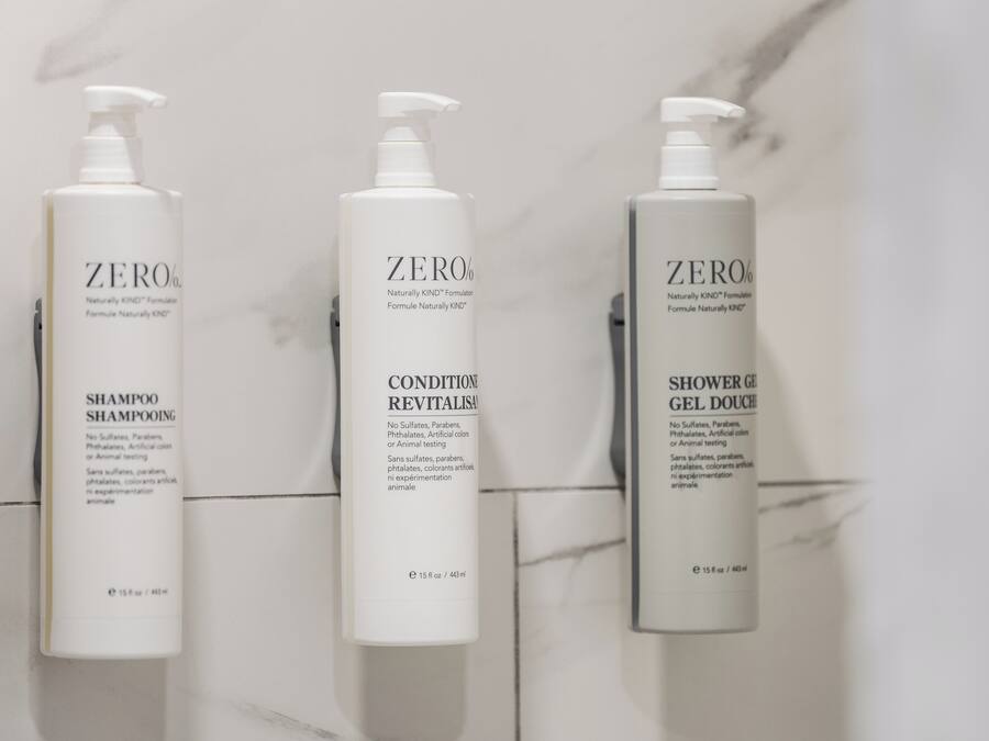 Three bottles of Zero% shampoo, conditioner, and shower gel.