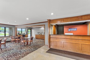 Welcome to our hotel lobby, featuring a reception desk, comfortable seating areas, and large windows offering views of the outdoors.