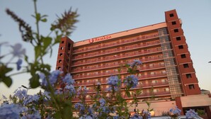 A multi-story building with the name "RAMADA" on the facade. - Ramada by Wyndham San Diego National City (National City)