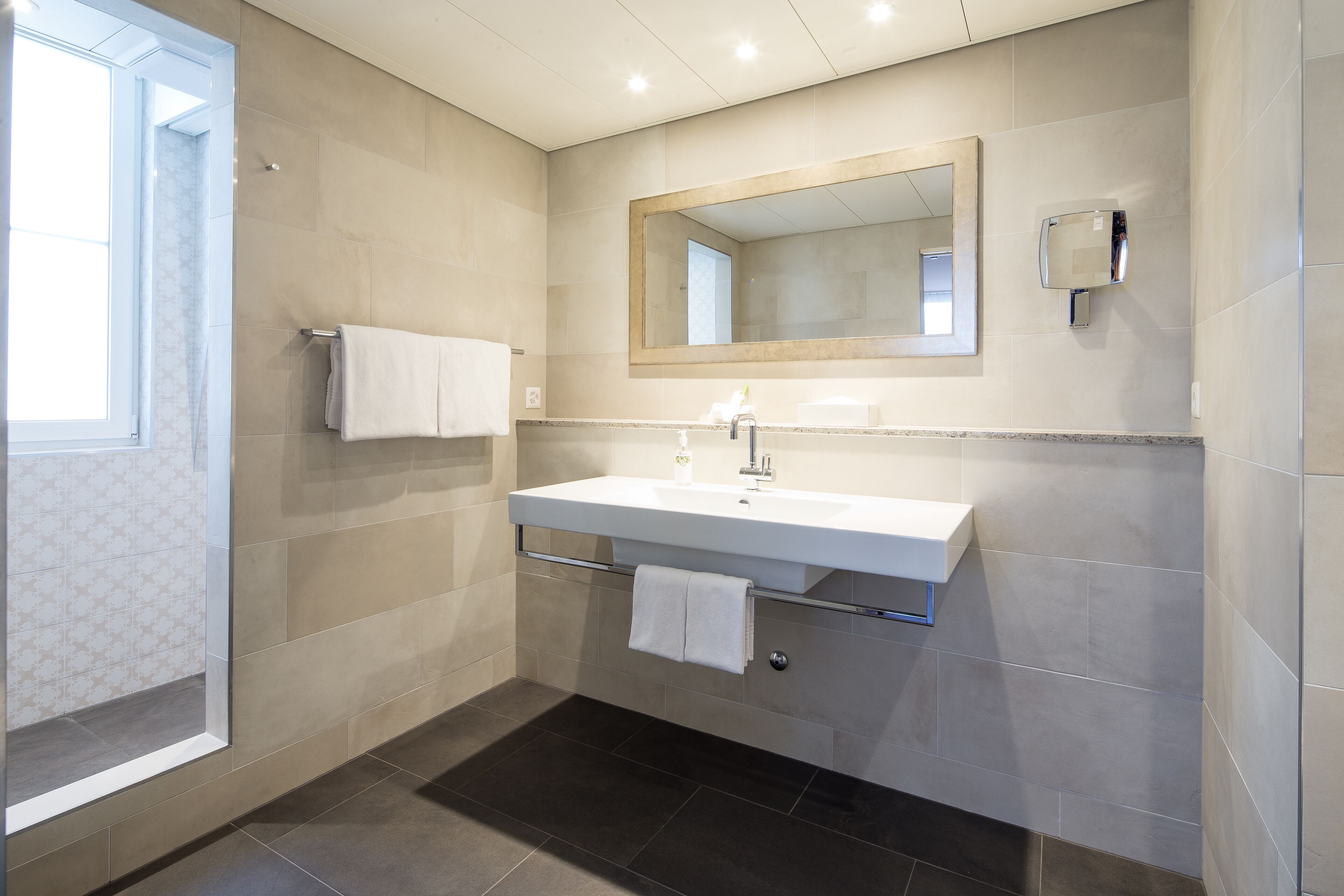 designer toiletries, hair dryer, towels