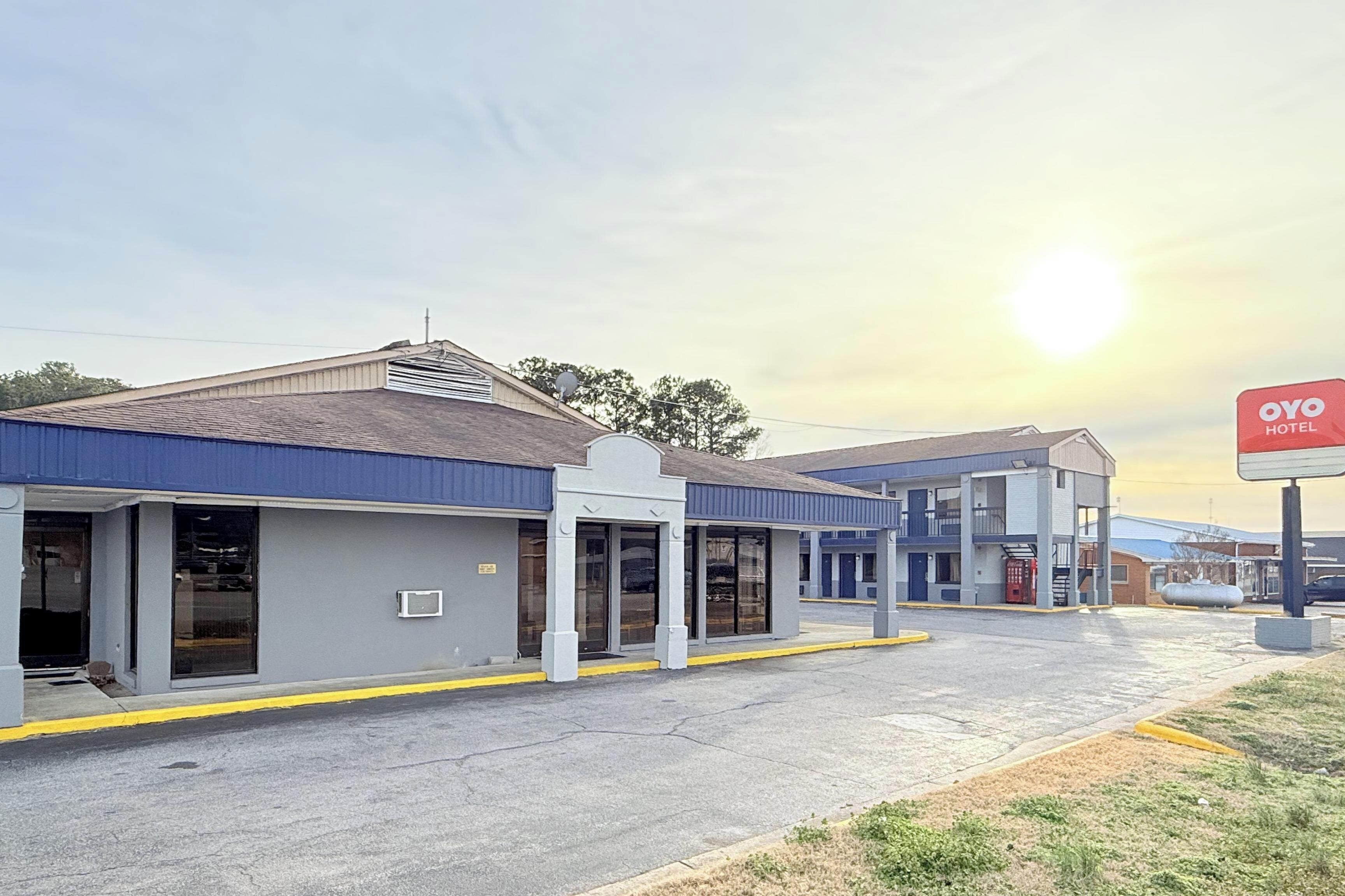 A hotel with a modern design, featuring a flat roof and a blue and white color scheme.