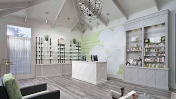 Relax in style amidst the elegant reception area, featuring a high ceiling, modern chandelier, and comfortable seating.