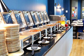 A buffet setup with multiple serving stations, including trays and utensils. - Bournemouth West Cliff Hotel & Spa (Bournemouth)
